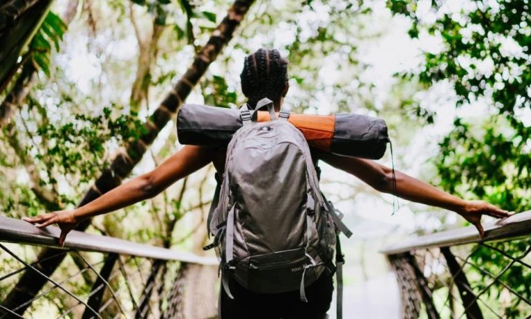 Woman in Nature With Backpack And Camping Gears